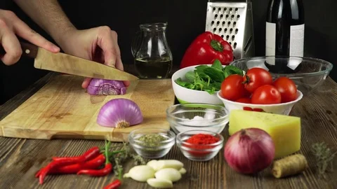Chef cutting up an onion with a knife Stock Footage
