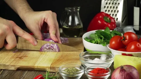 Chef cutting up an onion with a knife Stock Footage 74346041