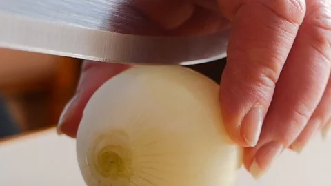 Chef cutting up an onion with a knife Stock Footage 88713842