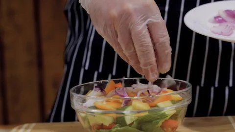 Chef cutting up an onion with a knife Stock Footage 127332794