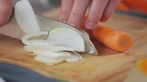 Chef Cutting Onion With Large Sharp Kitchen Knife On Wooden Chopping Board. Stock Footage 313732430