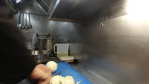 Chef cutting onion in a restaurant Stock Footage 125356606
