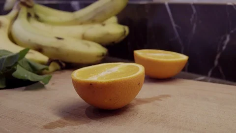 A chef cutting orange halves on cutting board Stock Footage 92845684