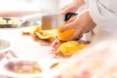 Chef cutting orange Stock Photos