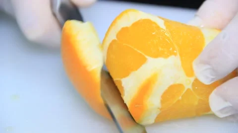 Chef cutting an orange on white cutting board 스톡 동영상 48397725