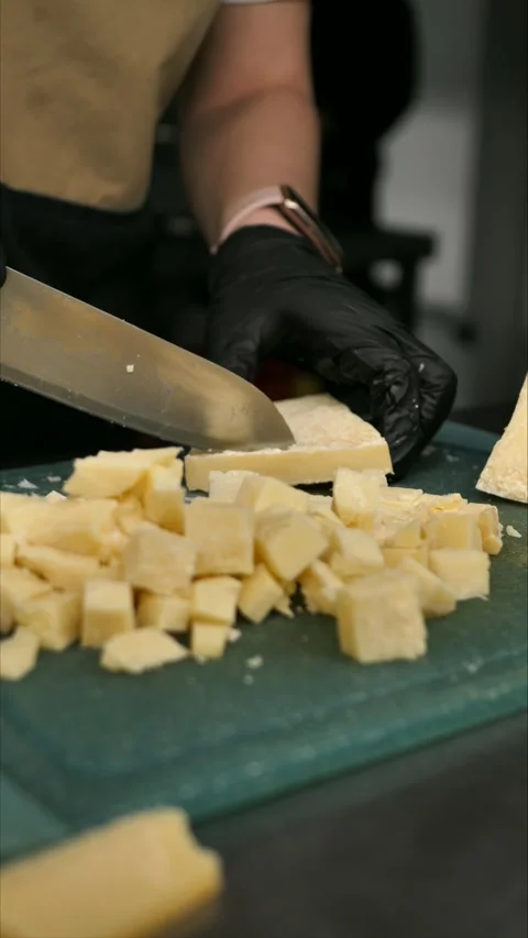 Chef cutting parmesan on a board. A gourmet appetizer or snack. Stock Footage 306211041