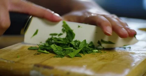 Chef Cutting Parsley on a Board 4K Stock Footage 79448320