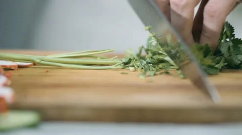 Chef cutting parsley in the kitchen with a sharp knife Stock Footage 68722055