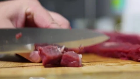 Chef cutting piece of beef meat with knife on wooden cutting board Stock Footage 334205137