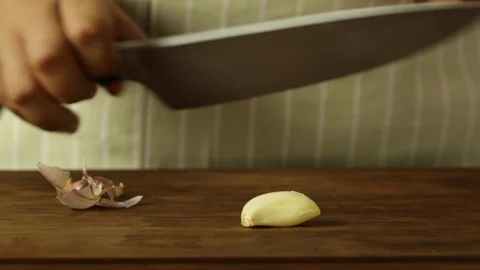 Chef Cutting into Pieces a Garlic Stock Footage 86135335