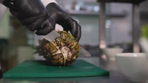 Chef cutting pineapple on green board Stock Footage 340887233