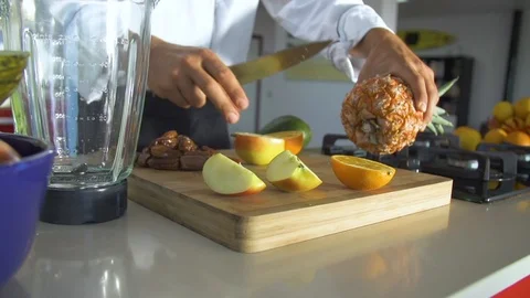Chef cutting pineapple with knife on chopping board in kitchen Video stock 85814677