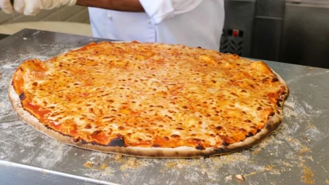 Chef cutting pizza with a round cutter knife Stock Footage 153608701