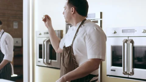 Chef cutting potatos with a mandolin in interior kitchen with soft day lighting. Stock Footage 199463161