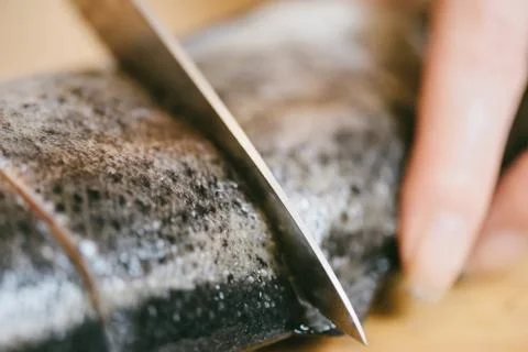 Chef cutting raw fish trout, close-up. Stock Photos