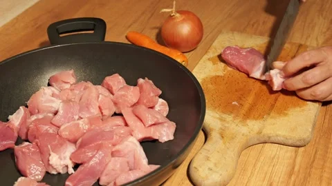Chef cutting raw pork meat on a wooden board 스톡 동영상 342758559