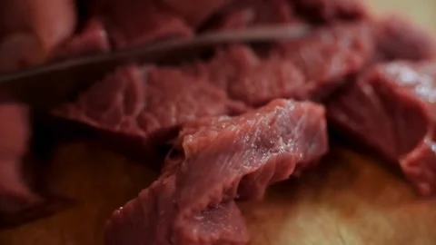 Chef cutting raw red beef meat on wooden board Stock Footage 333834588