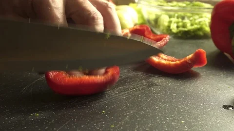 Chef cutting red bell pepper with a knife Stock Footage 83399030