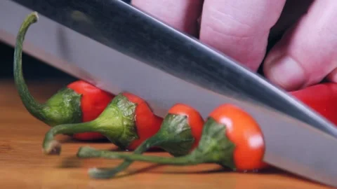 Chef is cutting red chilli pepper in slow motion. Stock Footage 140484171