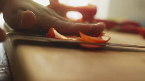 Chef cutting red pepper in layers on a cutting board Video stock 274673246
