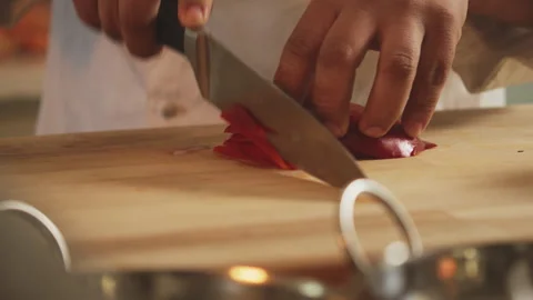 Chef cutting red pepper to strips on cutting board Stock Footage 274672963
