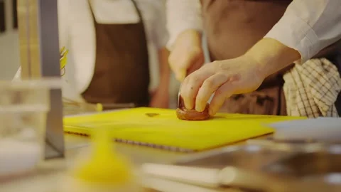 A chef is cutting a red pepper on a yellow cutting board Stock Footage 306576831