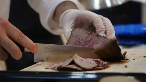 Chef cutting roast beef thin slices Stock Footage 108311476