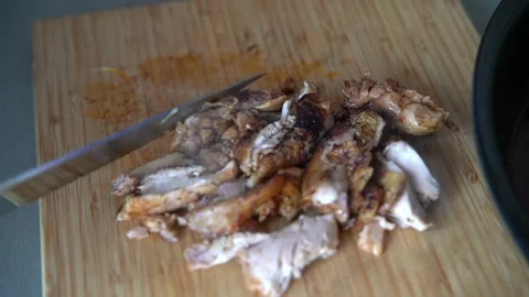 Chef cutting roasted boneless chicken thighs Stock Footage 158983700