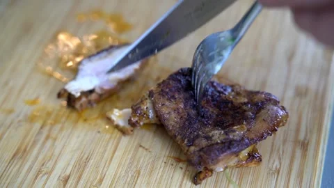 Chef cutting roasted boneless chicken thighs Stock Footage 158983721