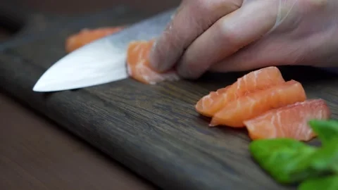 Chef cutting salmon fillet at professional kitchen Stock-Footage 130770710