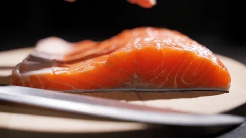Chef cutting salmon fish on fillets with knife Stock Footage 122738520