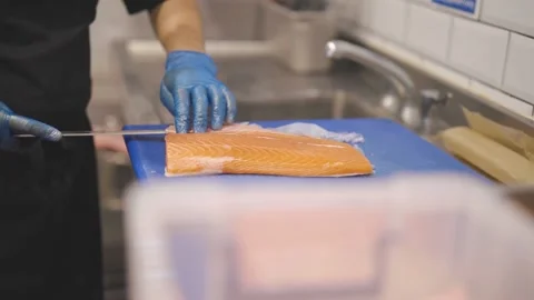 Chef Cutting Salmon Fish On Fillets With Knife Video stock 151030029