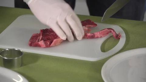 Chef cutting steak in strips Chef trimming fat of steaks  Stock Footage 101634840