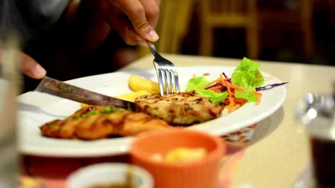 A chef is cutting a steak on a white plate in a professional manner. animation 库存影片 336581574