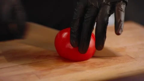 Chef is cutting a tomato in the kitchen. Close up Stock Footage 131152070