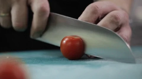 Chef cutting up a tomato with a knife Stock Footage 83205811
