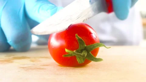 Chef cutting tomato with knife Stock Footage 153705400