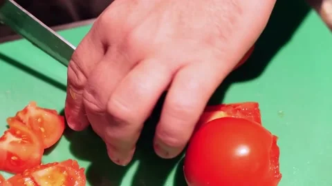The chef is cutting a tomato into small pieces Stock Footage 171360828