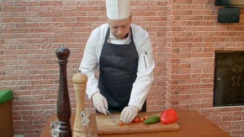 Chef cutting tomatoes in the kitchen Video stock 74936324