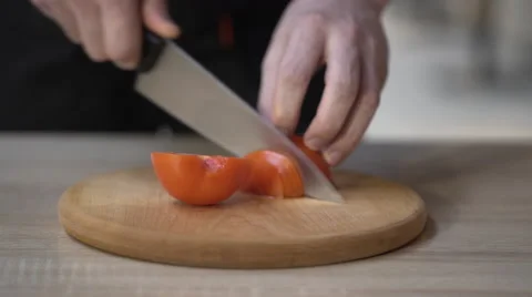 Chef cutting tomatoes at kitchen in a restaurant Stock Footage 61413787