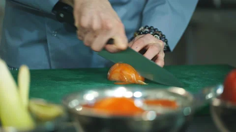 Chef is cutting vegetables at commercial kitchen Stock Footage 87408507