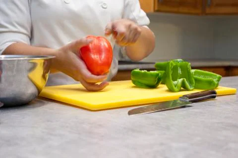 Chef cutting vegetables in kitchen Stock Photos
