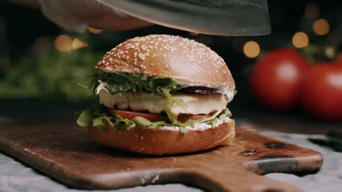 Chef Cutting Veggie Burger In Half With A Sharp Hand Made Knife Video stock 134406573