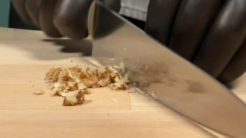 Chef cutting walnut with kitchen knife Stock Footage 306803626