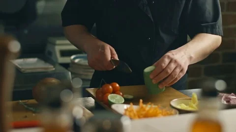 The chef is cutting zucchini to cook a dish Stock Footage 73349099