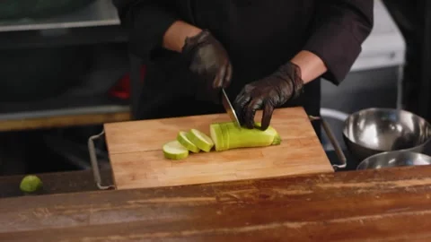 Chef is cutting zucchini in the kitchen. Close up Stock Footage 131152059