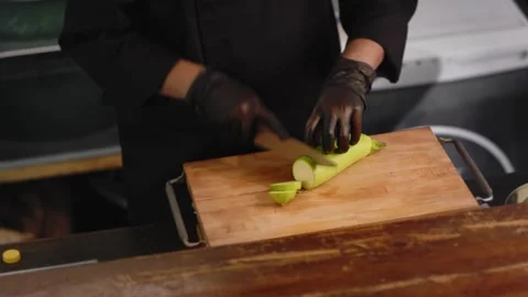 Chef is cutting zucchini in the kitchen. Close up Stock Footage 131152062
