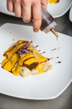 Chef decorate a dish Stock Photos