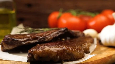 Chef decorated the dish with steaks with a sprig of rosemary Stock Footage 115831243