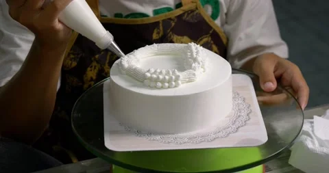 The chef decorated the white cake with whipped cream. Stock Footage 221004363